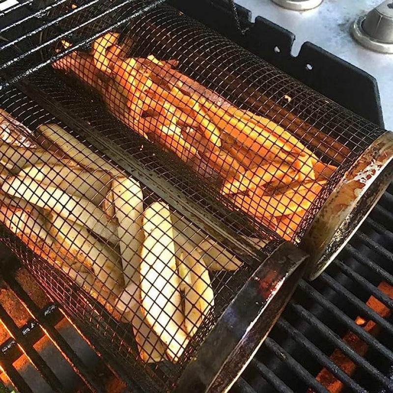 Fries and vegetables being cooked in a deep fryer basket over a flame.